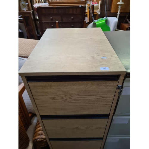 188 - An oak effect four drawer office filing cabinet - approx. 135.5cm high x 47cm wide x 65cm deep