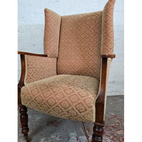 192 - A mid 20th century beech and pink upholstered armchair with later added Edwardian mahogany supports ... 