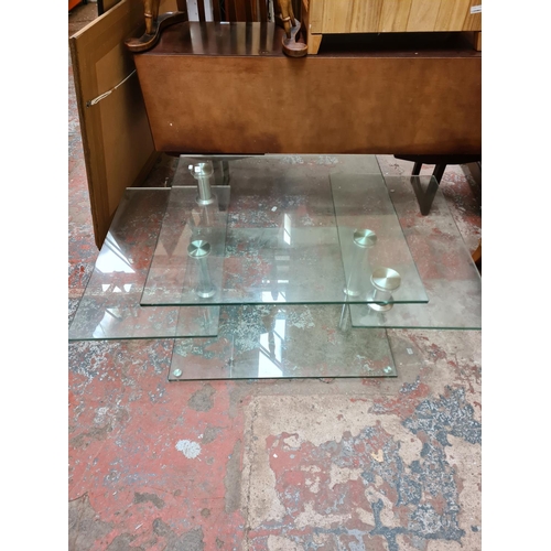 198 - A contemporary glass and chrome effect four tier coffee table