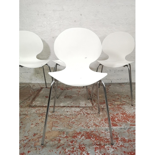 215 - A set of four contemporary white plastic stacking dining chairs