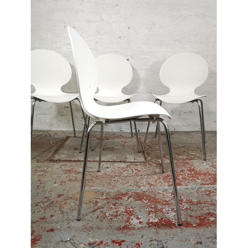 215 - A set of four contemporary white plastic stacking dining chairs