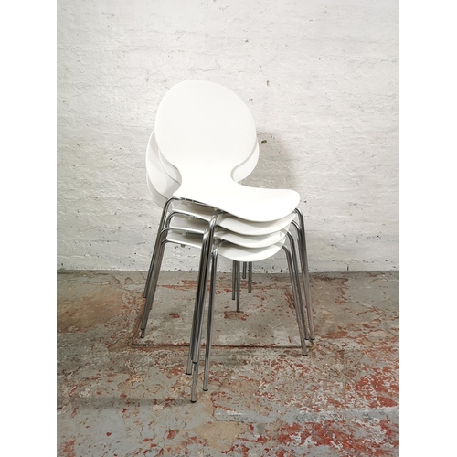 215 - A set of four contemporary white plastic stacking dining chairs