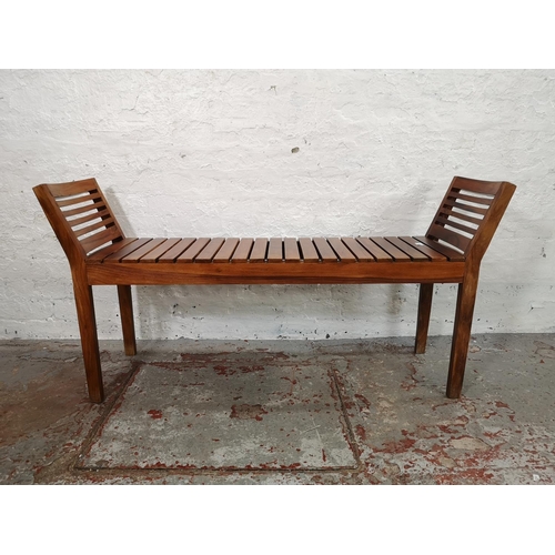 216 - Two Indonesian solid teak kartini chairs, one double - approx. 68cm high x 138cm wide x 37cm deep an... 