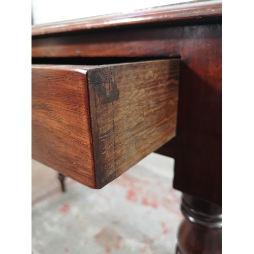 219 - A 19th century mahogany two drawer writing table with blue leather insert - approx. 75cm high x 90cm... 