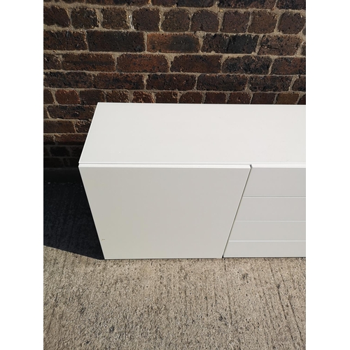 224 - A contemporary white painted sideboard with four central drawers and two outer cupboard doors - appr... 