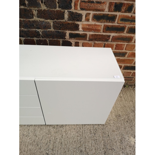 224 - A contemporary white painted sideboard with four central drawers and two outer cupboard doors - appr... 