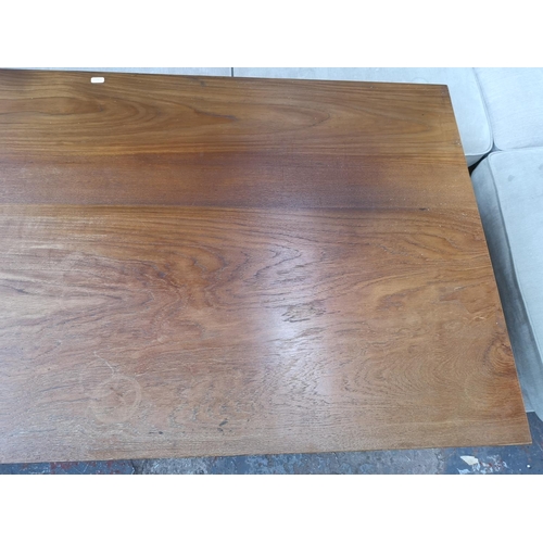 233 - An Indonesian solid teak office desk with three drawers and removable keyboard tray - approx. 69.5cm... 