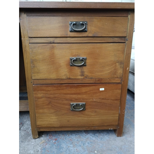 233 - An Indonesian solid teak office desk with three drawers and removable keyboard tray - approx. 69.5cm... 