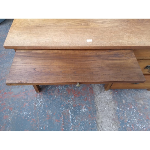 233 - An Indonesian solid teak office desk with three drawers and removable keyboard tray - approx. 69.5cm... 