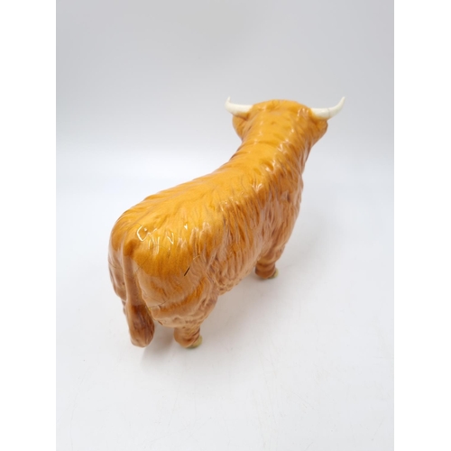 1127 - A three piece Beswick Highland cattle family