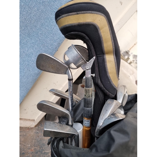 478 - A Wilson golf bag containing assorted golf clubs to include Prostaff, Wilson etc.