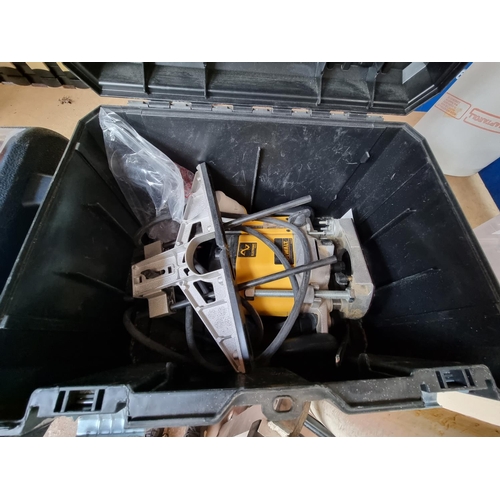 488 - Three boxed power tools, one Dewalt DW625EKT 110V plunge router with instruction manuals, one Bosch ... 