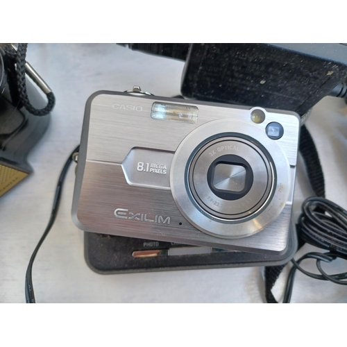 311 - A collection of cameras and optical equipment to include Casio EX-Z850 Exilim 8.1MP digital camera, ... 