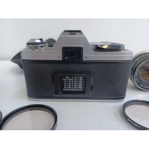 312 - Three items, one Minolta X-300 35mm SLR camera fitted with Rokkor-PF f=135mm tele-lens, one Tokina S... 