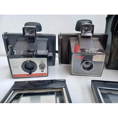 314 - Three Polaroid instant cameras, two Super Swinger land cameras and one Colorpack 80.