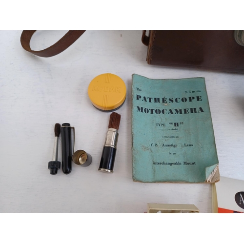 317 - A cased Pathescope Motocamera Type 'H' cine camera with accessories and instruction manual.