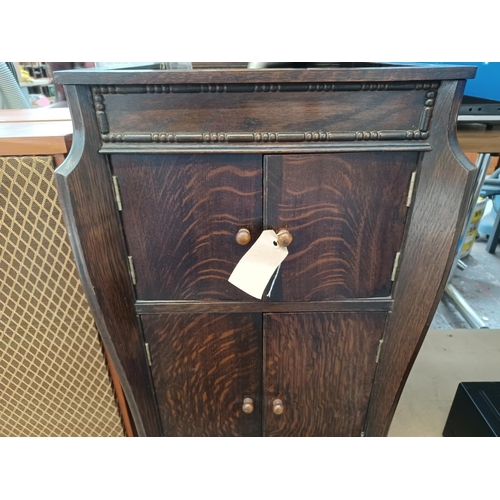 337 - A 1930's oak gramophone cabinet containing a wind-up gramophone with Goldring cartridge and a collec... 