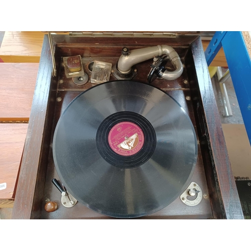 337 - A 1930's oak gramophone cabinet containing a wind-up gramophone with Goldring cartridge and a collec... 