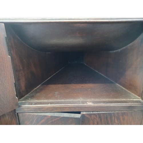 337 - A 1930's oak gramophone cabinet containing a wind-up gramophone with Goldring cartridge and a collec... 