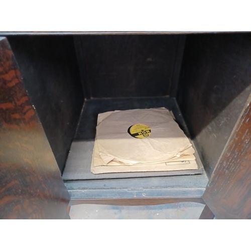 337 - A 1930's oak gramophone cabinet containing a wind-up gramophone with Goldring cartridge and a collec... 