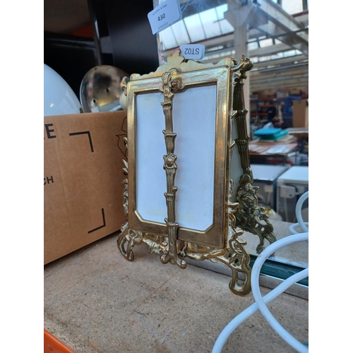 430 - Three items, one mirror effect table lamp, one matching mirror and one vintage brass picture frame