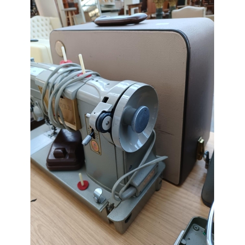 475 - A cased Singer 328K electric sewing machine