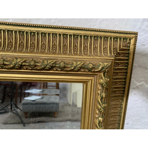 256 - A 19th century style gilt framed bevelled edge wall mirror - approx. 102cm wide x 73cm high