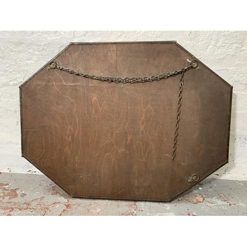 258 - An Arts & Crafts style copper framed oval bevelled edge wall mirror - approx. 63cm high x 82cm wide