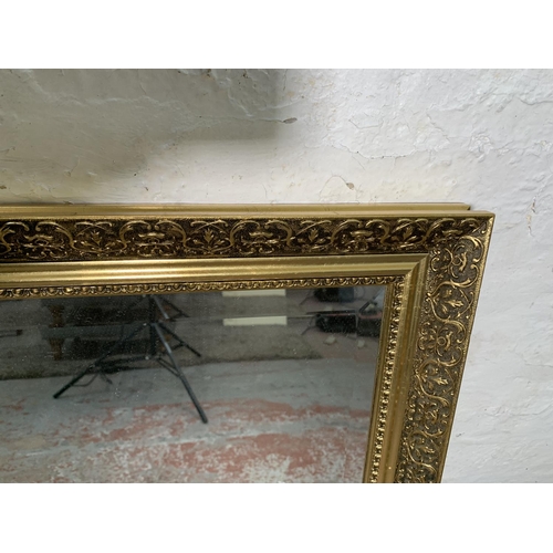 293 - Four various mirrors, one gilt framed and three mid 20th century bevelled edge frameless