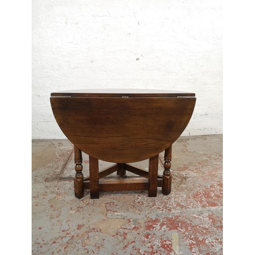 132 - An 18th century style carved oak drop leaf gateleg circular occasional table - approx. 58cm high x 6... 