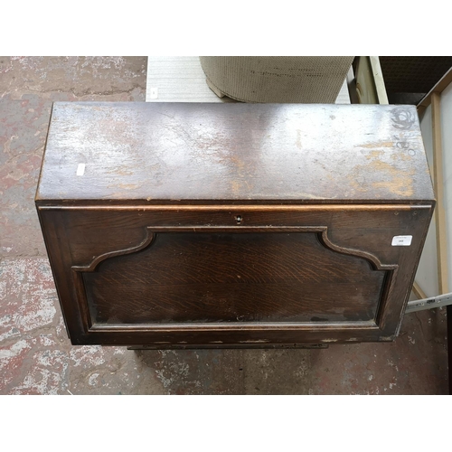 143 - A mid 20th century oak bureau with three drawers and fall front - approx. 100cm high x 76cm wide x 4... 