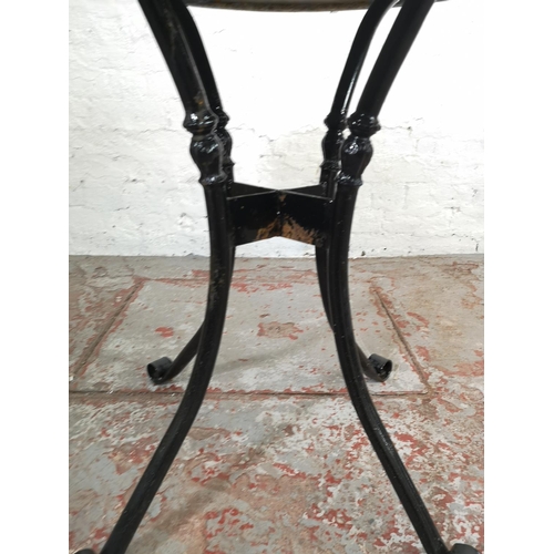 160 - A contemporary marble and black painted wrought iron circular patio table - approx. 73cm high x 77cm... 