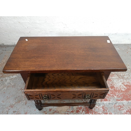 164 - A carved oak rectangular side table with single drawer - approx. 71cm high x 82cm wide x 42cm deep