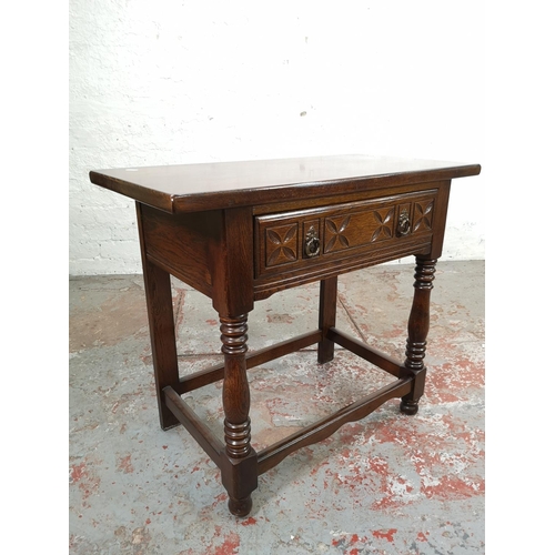 164 - A carved oak rectangular side table with single drawer - approx. 71cm high x 82cm wide x 42cm deep