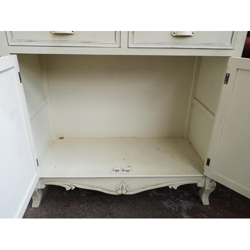 169 - A French style white painted and limed oak dresser with two glazed doors, two drawers and two lower ... 