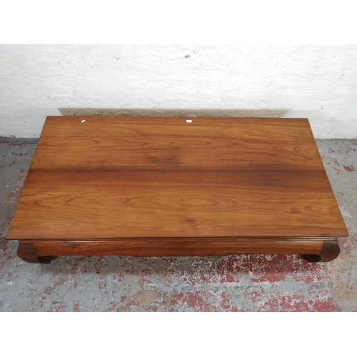 197 - An Indonesian solid teak low rectangular coffee table - approx. 42cm high x 88cm wide x 180cm long