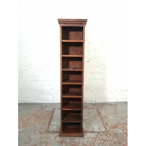 205 - An Indian sheesham wood eight tier freestanding CD rack - approx. 123cm high x 28.5cm wide x 19cm de... 