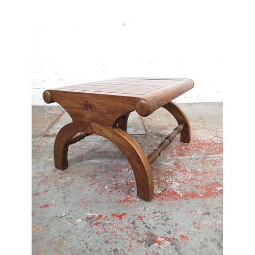 211 - An Indonesian solid teak plantation chair with matching stool - approx. 110cm high x 64cm wide x 76c... 