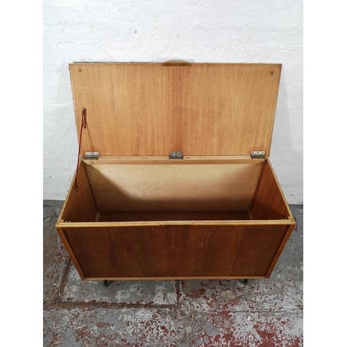 22c - A mid 20th century walnut and plywood blanket box with atomic supports - approx. 70cm high x 112 wid... 