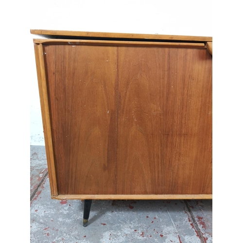 22c - A mid 20th century walnut and plywood blanket box with atomic supports - approx. 70cm high x 112 wid... 