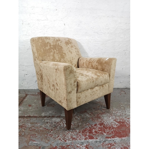 24 - A modern brown upholstered armchair with beech supports - approx. 88cm high x 73cm wide x 73cm deep