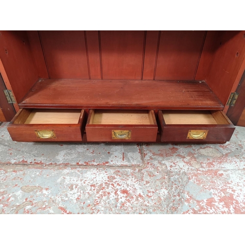 3 - An Edwardian mahogany two door bookcase with three internal shelves and three lower drawers - approx... 