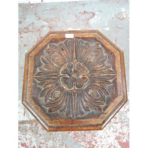 30 - An early/mid 20th century carved oak stool with floral design - approx. 39.5cm high x 30cm square