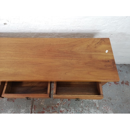 31 - An Indonesian teak three drawer console table - approx. 75cm high x 135cm wide x 40cm deep