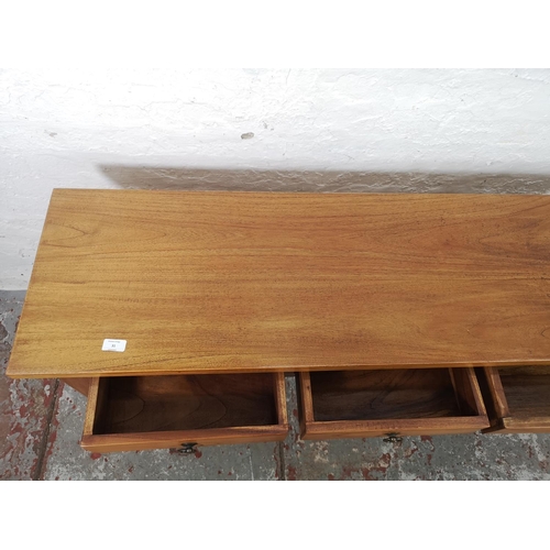 31 - An Indonesian teak three drawer console table - approx. 75cm high x 135cm wide x 40cm deep