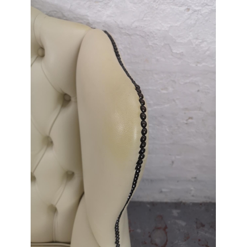 37 - A Chesterfield style white leatherette two seater wing back sofa - approx. 105cm high x 25cm wide x ... 