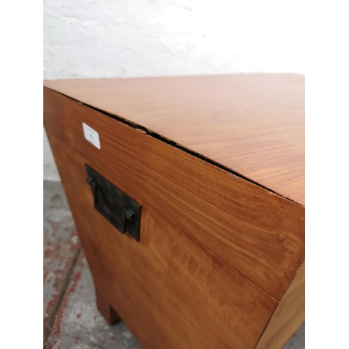 42 - An Indonesian teak sarcophagus shaped blanket box - approx. 51cm high x 82cm wide x 47cm deep