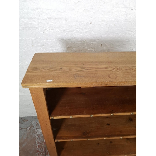 53 - A modern oak and pine four tier open bookcase - approx. 122cm high x 106cm wide x 30cm deep