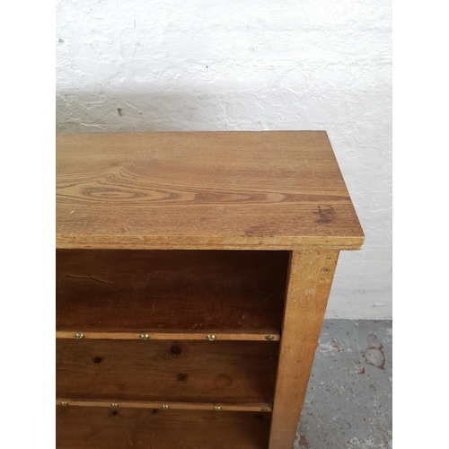 53 - A modern oak and pine four tier open bookcase - approx. 122cm high x 106cm wide x 30cm deep