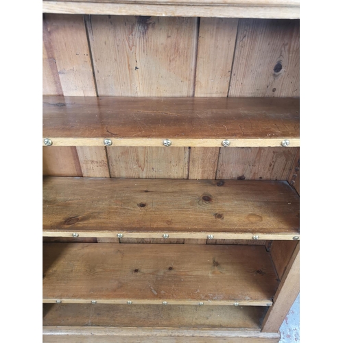 53 - A modern oak and pine four tier open bookcase - approx. 122cm high x 106cm wide x 30cm deep